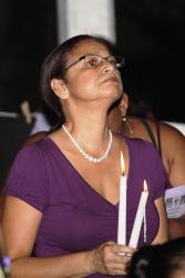 Maria Friday holds a candle in remembrance of her friend, Lorraine Joseph. Maria Friday holds a candle in remembrance of her friend, Lorraine Joseph.